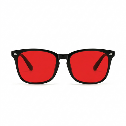 Glasses with red lenses and black frames on a white background